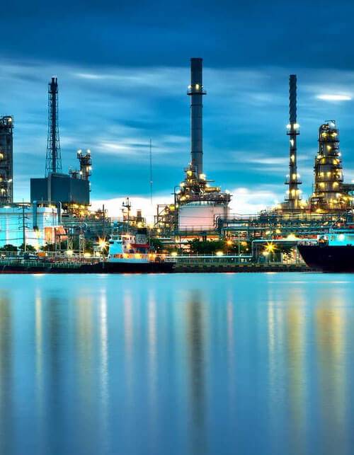 a large factory with a body of water