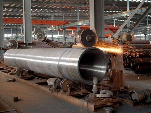 a large metal pipe with sparks flying